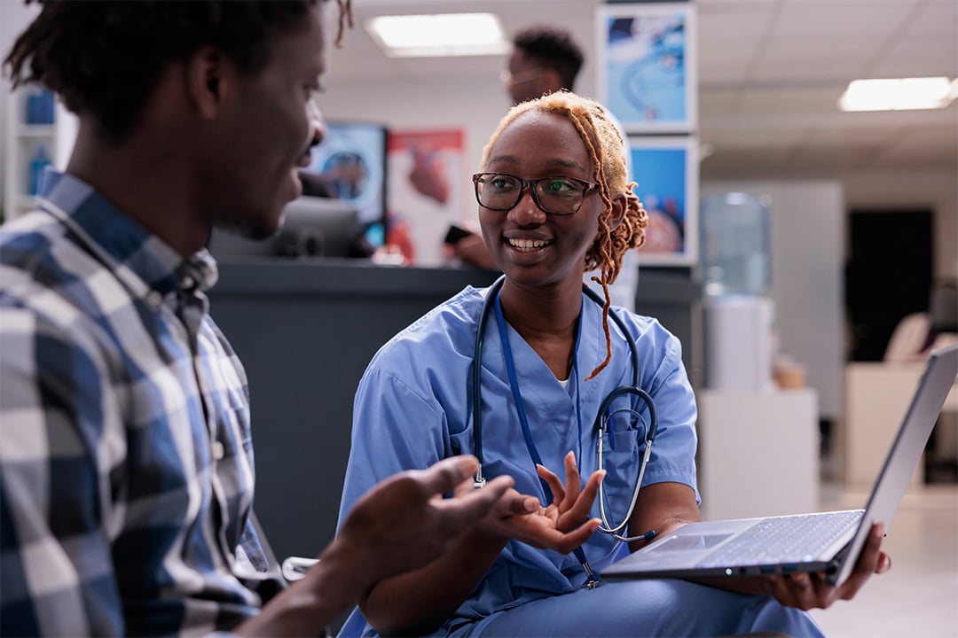 female-doctor-doing-patient-intake-in-health-center-waiting-room
