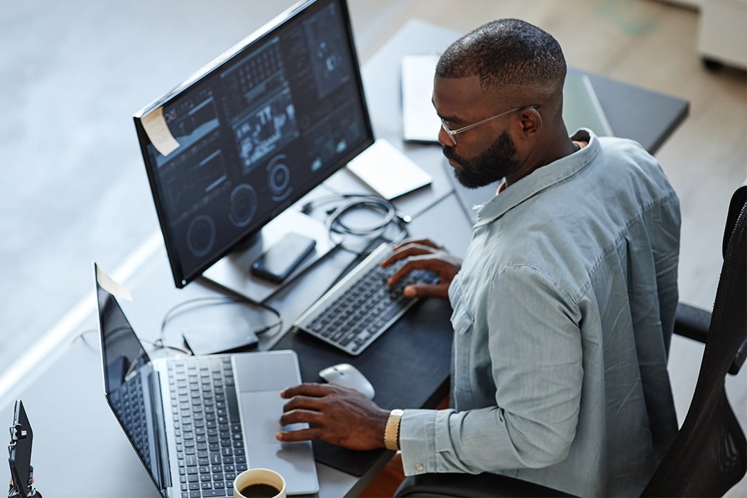 man-working-from-laptop-and-desktop-computer-CASCADING