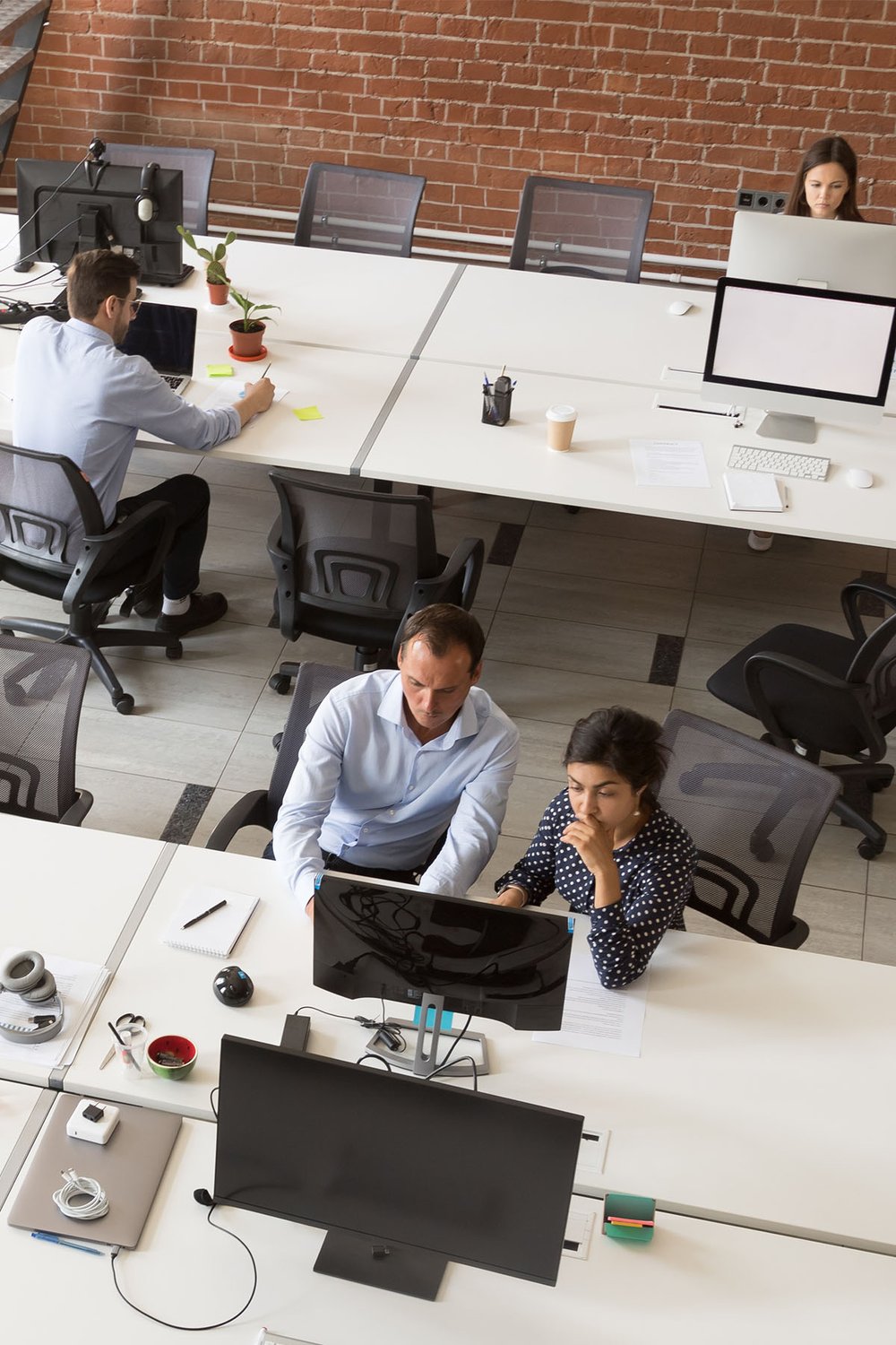 focused-team-working-from-computers-in-shared-workspace