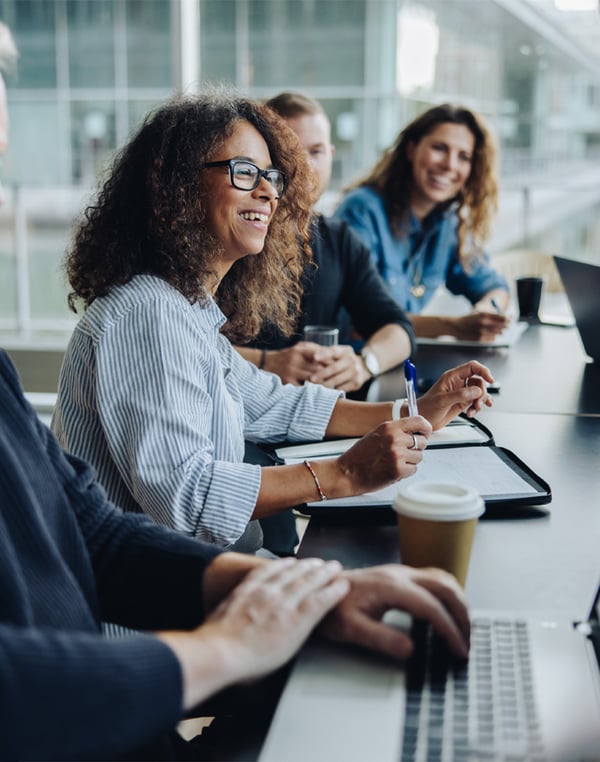 smiling-female-team-lead-in-meeting-at-coference-table