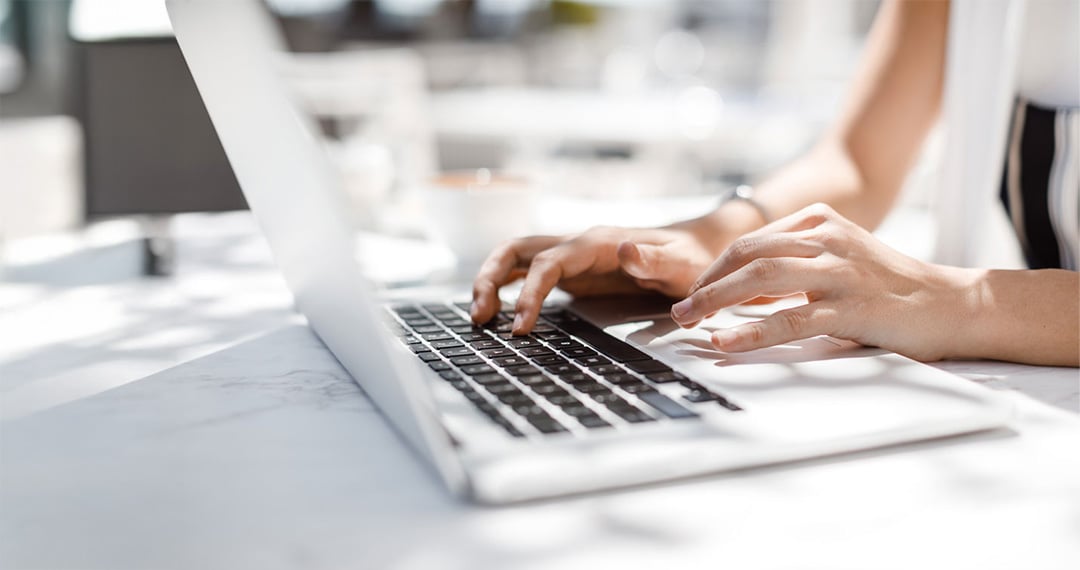 close-up-of-woman-typing-on-laptop