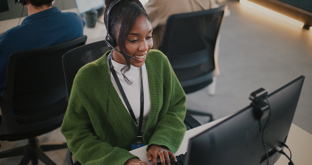woman-on-headset-typing-into-computer