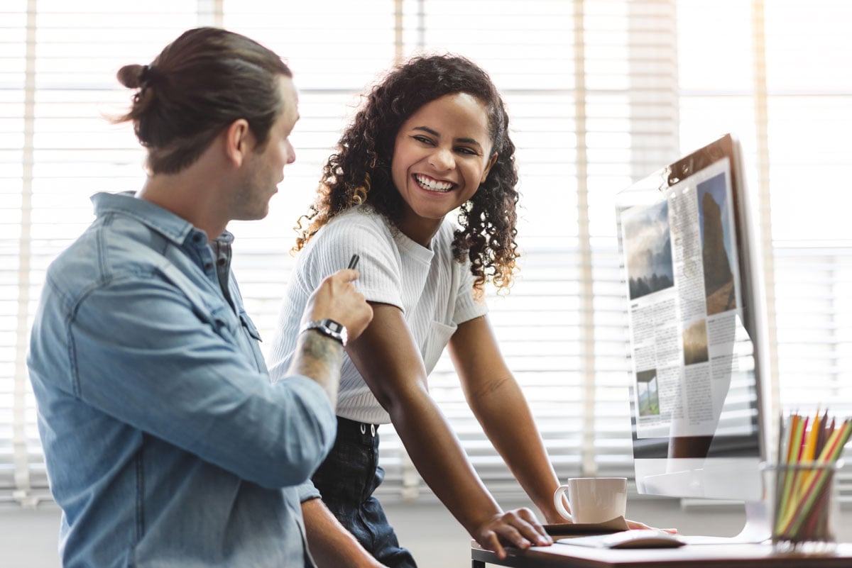 two-co-workers-talking-together