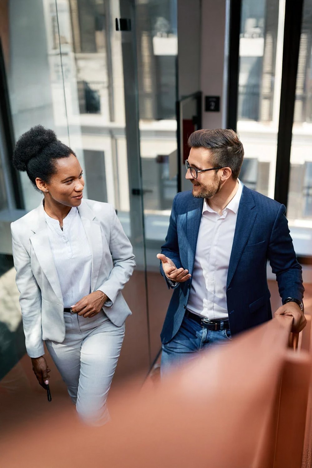 two-co-works-walking-together-VERTICAL